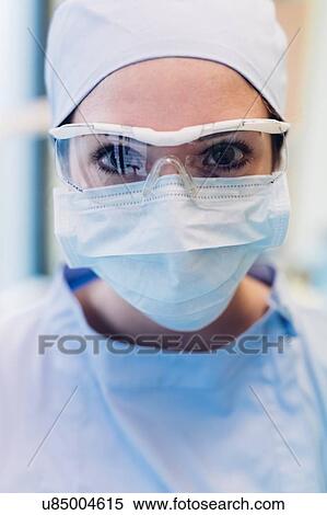 Portrait of female dentist, wearing surgical mask and protective eyewear, close-up View Large Photo Image Stock Photography - Portrait of female dentist, wearing surgical mask and protective eyewear, close-up. Fotosearch