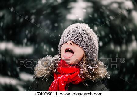 Portrait of girl catching falling snow on tongue View Large Photo Image Stock Image - Portrait of girl catching falling snow on tongue. Fotosearch