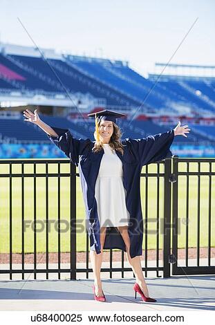 Stock Photography - Portrait of graduate student in stadium. Fotosearch