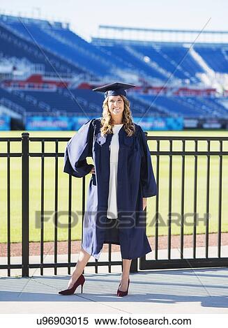 Stock Photography - Portrait of graduate student in stadium. Fotosearch