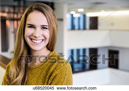 Portrait of happy young businesswoman in office atrium, head and shoulders View Large Photo Image Stock Photography - Portrait of happy young businesswoman in office atrium, head and shoulders. Fotosearch