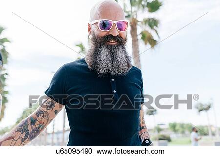 Stock Image - Portrait of mature male hipster in sunglasses. Fotosearch