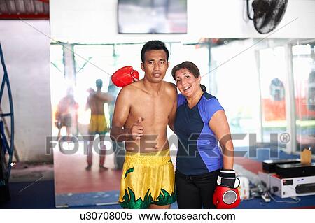 Portrait of mature woman with boxing trainer in gym View Large Photo Image Stock Photography - Portrait of mature woman with boxing trainer in gym. Fotosearch