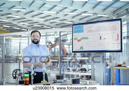Stock Photography - Portrait of robot engineer in robotics research facility. Fotosearch