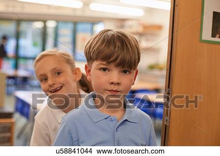 Portrait of schoolboy and girl in classroom at primary school View Large Photo Image Picture - Portrait of schoolboy and girl in classroom at primary school. Fotosearch