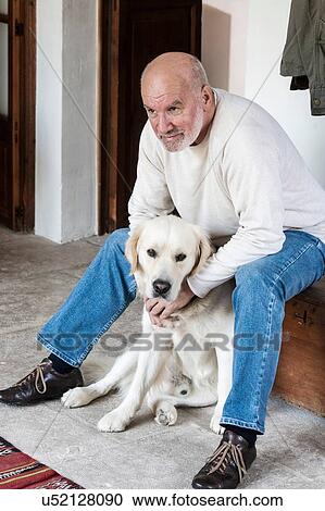 Portrait of senior man at home with pet dog View Large Photo Image Stock Image - Portrait of senior man at home with pet dog. Fotosearch