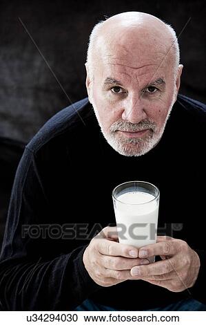 Portrait of senior man, holding glass of milk View Large Photo Image Stock Image - Portrait of senior man, holding glass of milk. Fotosearch