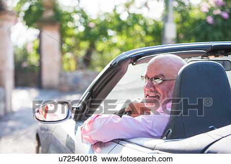 Portrait of senior man in convertible car View Large Photo Image Stock Photo - Portrait of senior man in convertible car. Fotosearch