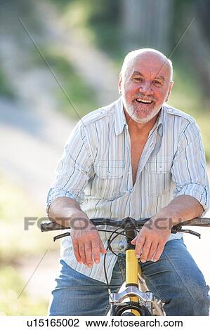 Portrait of senior man on bicycle View Large Photo Image Stock Image - Portrait of senior man on bicycle. Fotosearch