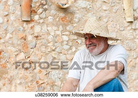 Portrait of senior man, outdoors, wearing straw hat View Large Photo Image Stock Photograph - Portrait of senior man, outdoors, wearing straw hat. Fotosearch