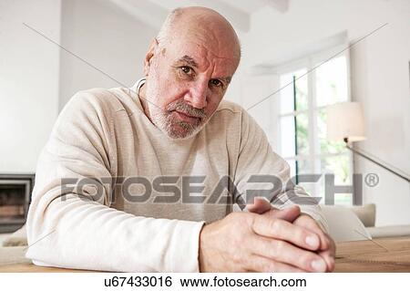 Stock Photograph - Portrait of senior man, pensive expression. Fotosearch