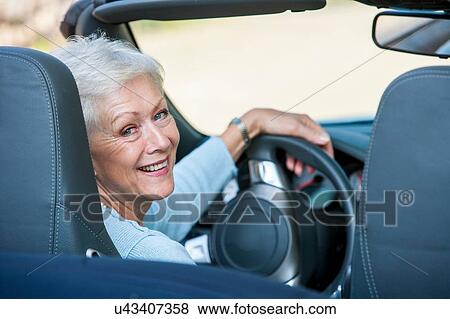 Portrait of senior woman in convertible car View Large Photo Image Stock Photo - Portrait of senior woman in convertible car. Fotosearch