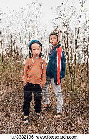 Portrait of two brothers, outdoors, wearing knitted hats, making faces View Large Photo Image Stock Photograph - Portrait of two brothers, outdoors, wearing knitted hats, making faces. Fotosearch