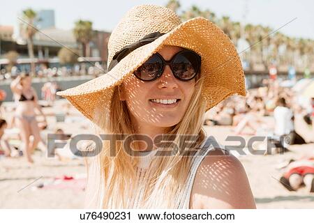 Stock Image - Portrait of woman on beach, Barcelona, Catalonia, Spain. Fotosearch
