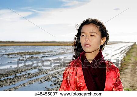 Portrait of young asian woman on beach in traditional clothing, Tarragona, Catalonia, Spain View Large Photo Image Stock Photo - Portrait of young asian woman on beach in traditional clothing, Tarragona, Catalonia, Spain. Fotosearch