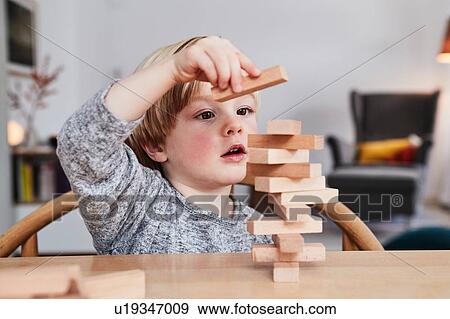 Portrait of young boy, building structure with wooden building blocks View Large Photo Image Stock Photo - Portrait of young boy, building structure with wooden building blocks. Fotosearch