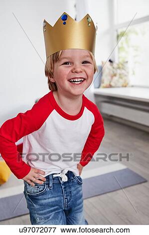 Portrait of young boy, wearing cardboard crown, smiling View Large Photo Image Stock Photo - Portrait of young boy, wearing cardboard crown, smiling. Fotosearch