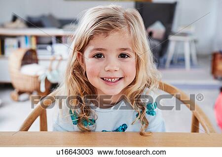 Portrait of young girl, sitting at table, smiling View Large Photo Image Stock Image - Portrait of young girl, sitting at table, smiling. Fotosearch