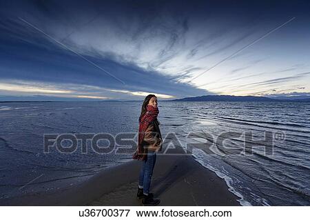 Portrait of young woman on beach at dusk, Tarragona, Catalonia, Spain View Large Photo Image Stock Photo - Portrait of young woman on beach at dusk, Tarragona, Catalonia, Spain. Fotosearch