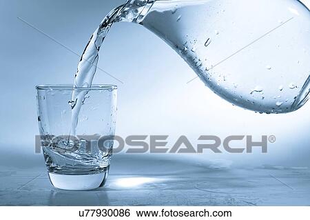 Stock Photograph - Pouring water into glass from a jug.. Fotosearch