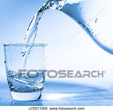 Stock Photography - Pouring water into glass from a jug.. Fotosearch
