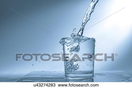 Pouring water into glass. View Large Photo Image Stock Image - Pouring water into glass.. Fotosearch