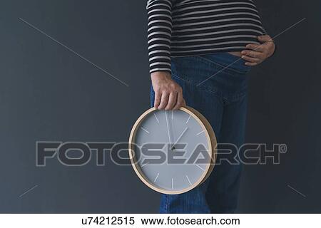 Stock Photography - Pregnant female with clock.. Fotosearch