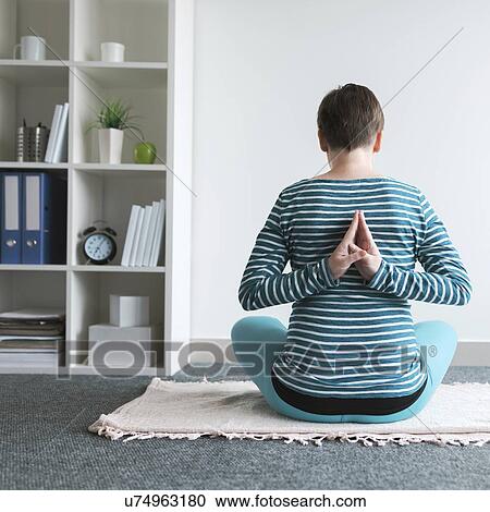 Stock Image - Pregnant woman practicing yoga.. Fotosearch