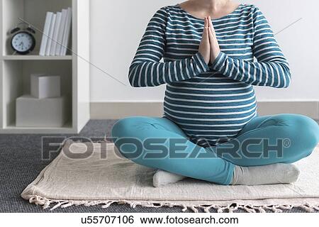 Stock Photograph - Pregnant woman practicing yoga.. Fotosearch