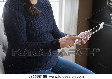 Pregnant woman using digital tablet View Large Photo Image Stock Photograph - Pregnant woman using digital tablet. Fotosearch