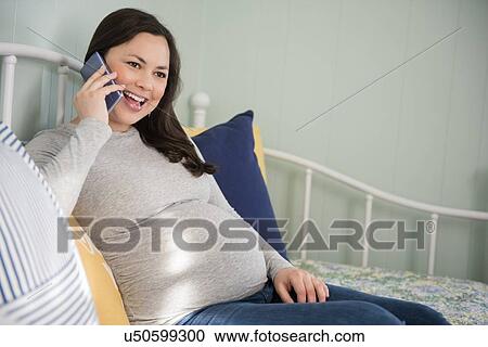 Pregnant woman using smart phone View Large Photo Image Stock Image - Pregnant woman using smart phone. Fotosearch