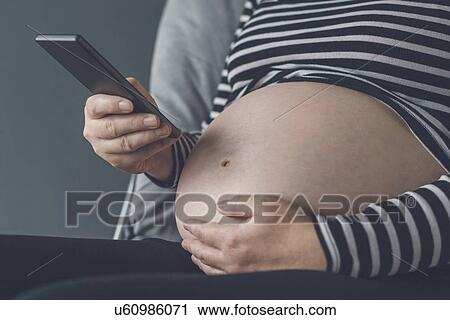 Pregnant woman using smartphone. View Large Photo Image Stock Image - Pregnant woman using smartphone.. Fotosearch