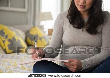 Pregnant woman writing journal View Large Photo Image Stock Photo - Pregnant woman writing journal. Fotosearch