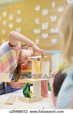 Primary schoolgirl making a cardboard structure on classroom desks View Large Photo Image Stock Image - Primary schoolgirl making a cardboard structure on classroom desks. Fotosearch