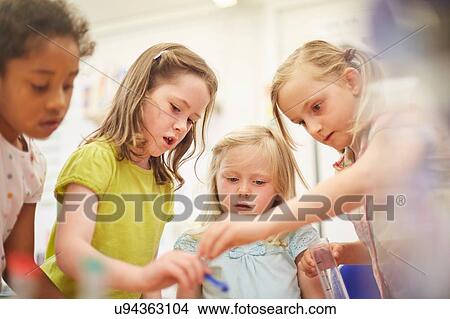 Primary schoolgirls doing experiment in classroom View Large Photo Image Picture - Primary schoolgirls doing experiment in classroom. Fotosearch