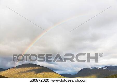 Rainbow over mountain landscape, Jotunheimen National Park, Lom, Oppland, Norway View Large Photo Image Stock Image - Rainbow over mountain landscape, Jotunheimen National Park, Lom, Oppland, Norway. Fotosearch