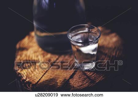 Stock Photo - Rakia alcoholic drinking bottle with shot glass.. Fotosearch