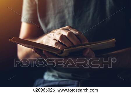 Stock Photography - Reading an old book.. Fotosearch