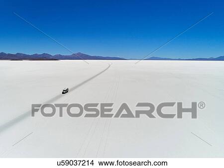 Picture - Recreational vehicle, travelling across salt flats, Salar de Uyuni, Uyuni, Oruro, Bolivia, South America. Fotosearch