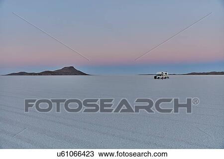 Stock Image - Recreational vehicle, travelling across salt flats, Salar de Uyuni, Uyuni, Oruro, Bolivia, South America. Fotosearch