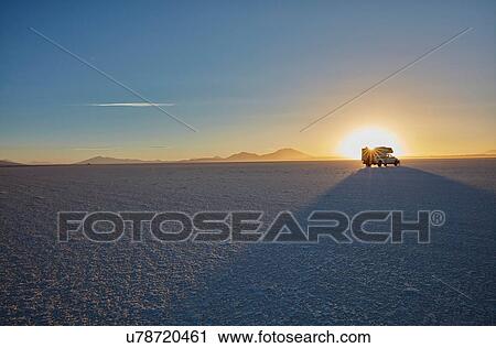 Stock Image - Recreational vehicle, travelling across salt flats, Salar de Uyuni, Uyuni, Oruro, Bolivia, South America. Fotosearch