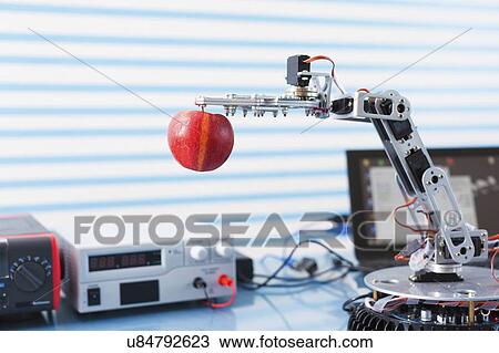 Robotic arm holding apple. View Large Photo Image Stock Image - Robotic arm holding apple.. Fotosearch