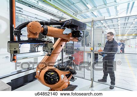 Robotics engineer operating robot aided CNC machine in robotics research facility View Large Photo Image Stock Image - Robotics engineer operating robot aided CNC machine in robotics research facility. Fotosearch