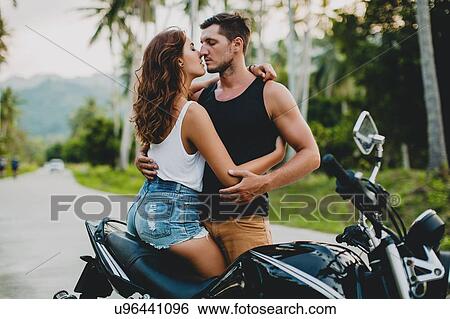 Romantic young couple embracing by motorcycle on rural road, Krabi, Thailand View Large Photo Image Stock Photograph - Romantic young couple embracing by motorcycle on rural road, Krabi, Thailand. Fotosearch