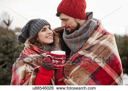 Romantic young couple wrapped in blanket while shopping for christmas tree from forest View Large Photo Image Stock Photograph - Romantic young couple wrapped in blanket while shopping for christmas tree from forest. Fotosearch