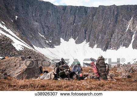 Stock Photo - Rucksacks on edge of crater, Ural, Sverdlovsk, Russia. Fotosearch