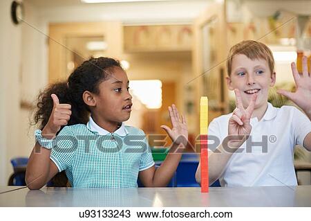 Schoolboy and girl counting on fingers in classroom at primary school View Large Photo Image Stock Image - Schoolboy and girl counting on fingers in classroom at primary school. Fotosearch