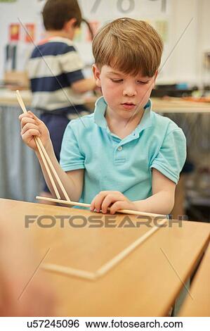 Schoolboy making ball and stick model in classroom at primary school View Large Photo Image Stock Photograph - Schoolboy making ball and stick model in classroom at primary school. Fotosearch