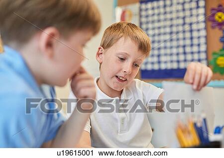 Schoolboys learning together in classroom lesson at primary school View Large Photo Image Stock Image - Schoolboys learning together in classroom lesson at primary school. Fotosearch