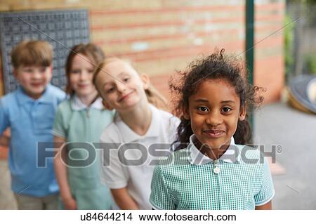 Schoolgirls and boys standing outside primary school building, portrait View Large Photo Image Picture - Schoolgirls and boys standing outside primary school building, portrait. Fotosearch
